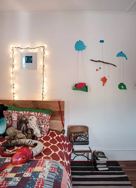 Their older son’s bedroom features his parents’ handiwork. Szlasa made the headboard from reclaimed wood and Rodabaugh stitched the quilt as well as the hanging mobile.