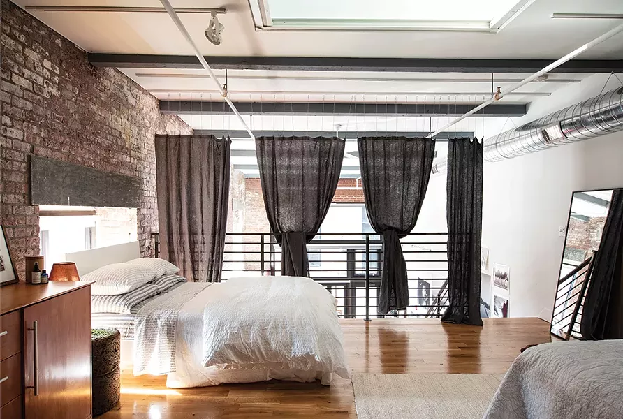The upstairs sleeping loft features a dresser from the Italian design house Calligaris as well as Pilkington’s handmade textiles. Rice’s framer made her mirrors for the space and architect Aryeh Siegal helped her hang privacy curtains. - PHOTO: DEBORAH DEGRAFFENREID