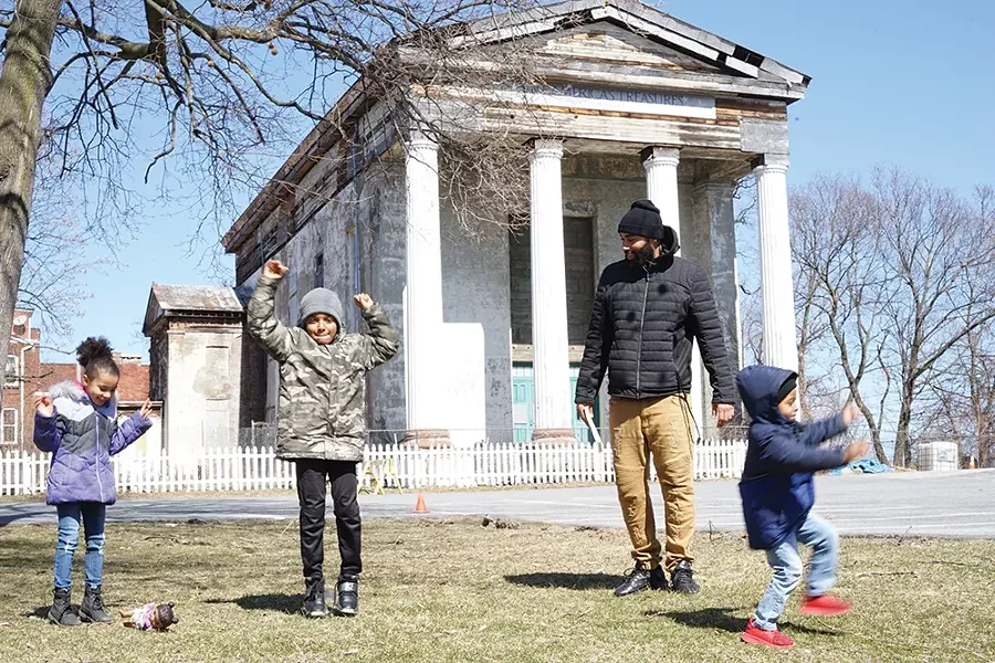 Carmela, Zach Jr., Giovanni, and Zachary Murry in front of the Dutch Reformed Church on Grand Street. - PHOTO: JOHN GARAY