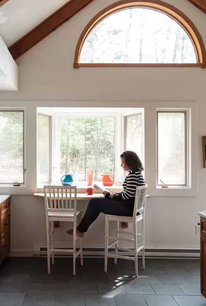 Alison Stewart in the sunny kitchen of her Woodstock retreat overlooking the woods. As of late, the home’s solitude has lent itself well to reading the authors she hosts on her WNYC program “All of It.” “It’s a dream job,” she explains, “especially for a working mom who was an English major. In the past six months, we’ve had 570 guests.” She adds, “I really think if someone has spent all that time working on a book, I should offer them the - courtesy of trying my best to read it.” - PHOTO: DEBORAH DEGRAFFENREID