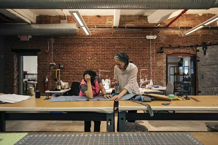 Artist Sigi Ahl with a Tiny Factory employee.