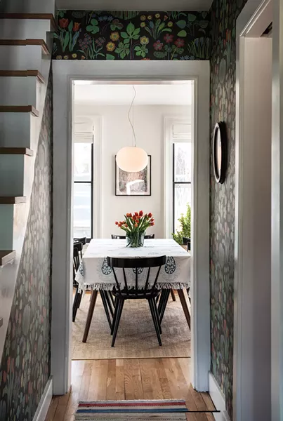 A view to the home’s dining table, adorned with flowers. In 2016, Walker joined with flower farmer Marina Michahelles to form the nonprofit Abloom, which specializes in flower recovery. Along with a group of volunteers, the two gather flowers after weddings and other events, retrim the stems, and then distribute the still fresh, seasonal flowers to women’s shelters and other institutional living spaces throughout the Hudson Valley. “It’s a very straightforward, noncontroversial thing - to give people flowers. What’s not to love? Everyone deserves some beauty,” explains Walker. “What we didn’t realize was how powerful it was going to be for people to have something beautiful in their rooms. It reminds them of their value as humans.” - PHOTO: DEBORAH DEGRAFFENREID