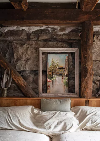 “Everything was very rustic,” remembers Blue, - describing the home’s original first floor. Originally small horse barn, Blue sealed it and sheetrocked part of the interior to keep out dirt. However, he was able to preserve the space’s original stone walls and oak beams. The original horse entrance was converted into windows. - PHOTO: DEBORAH DEGRAFFENREID