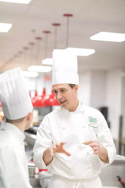 Chef Kaywork and a student in the kitchen, talking history and food. - PHOTO COURTESY OF CIA