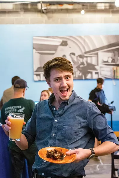 Chronogram sales development lead Thomas Hansen enjoys the food and drink donated by Sloop Brewing Company at the August Chronogram Conversation. - PHOTO: ANNA SIROTA