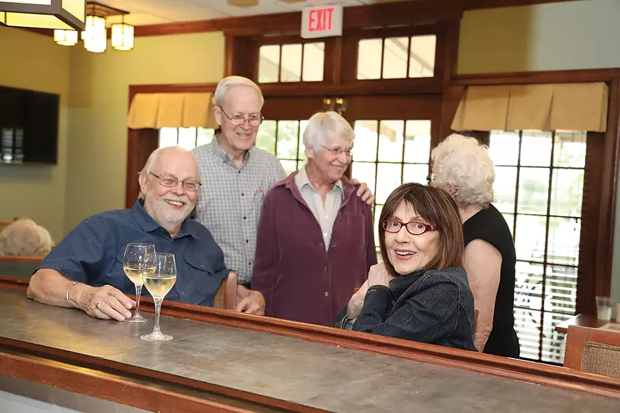 friends catch up at Woodland Pond’s pub.