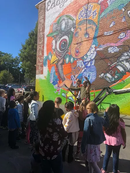 Artist Risa Tochigi discussing her mural with Kingston students. - PHOTOS COURTESY OF O+ FESTIVAL