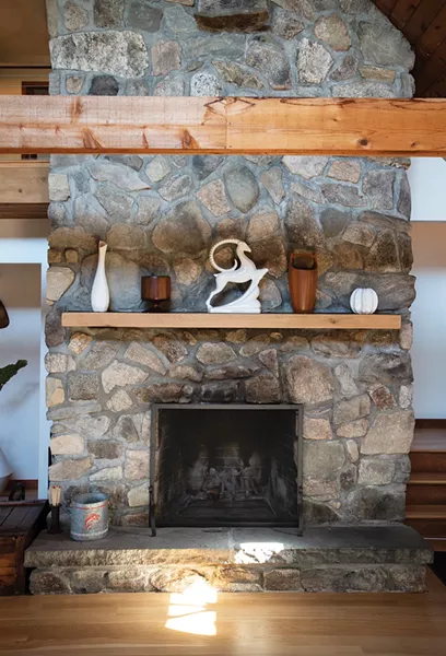 A refurbished bluestone fireplace sits at the home’s center. It was the first thing the couple noticed on their initial visit. “We’ve had so many adventures and good times exploring areas and finding cool stuff to fill the house,” says Davis. The white Haeger antelope sculpture was a regift from friends in Brooklyn who received it as a thank-you present from a drag queen who - had crashed on their couch. “I know we’ve picked out a cool piece when the kids who come over are obsessed with it or crawling all over it,” says Moser. “Everyone wants to interact with it.” - PHOTO: DEBORAH DEGRAFFENREID