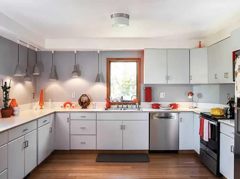 The kitchen of Jordan Moser and Hilary Davis gutted and redesigned the home’s open kitchen then filled it with an eclectic assortment of refurbished finds. “It makes us so happy to bring old, forgotten objects back to life,” says Davis. - PHOTO: DEBORAH DEGRAFFENREID