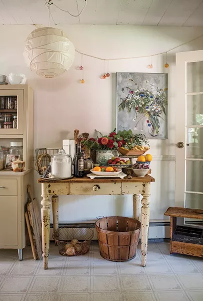 The side table in Melina Hammer and Jim Lafferty’s kitchen is full of ingredients. The food and flowers are all from their garden, foraged from nearby woods or gathered from local farms. The couple host Airbnb guests almost every weekend in their home and Hammer specializes in cooking custom multi-course menus. “We love - showcasing the incredible flavors or wild foods paired with thoughtfully grown and harvested cultivated foods of the season,” says Lafferty. - PHOTO: DEBORAH DEGRAFFENREID