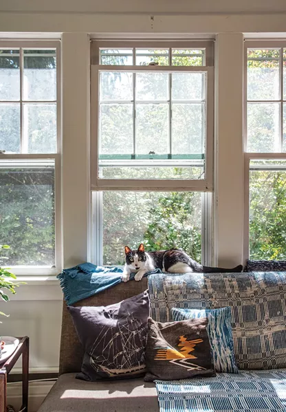 The home’s living room looks out to the natural bounty of the Hudson Valley. “With each season, we’ve loved learning about the particulars of nature in a new ways,” says Lafferty. - PHOTO: DEBORAH DEGRAFFENREID