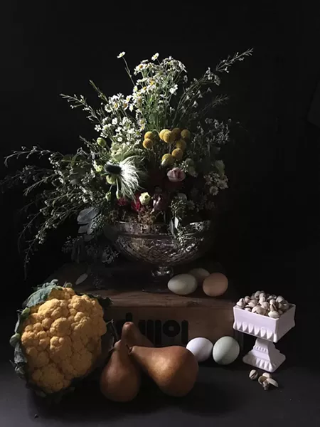 An arrangement of feverfew, jackpot thistle, craspedia, lisianthus, seeded eucalyptus, and wax flower by Earthgirl Flowers.