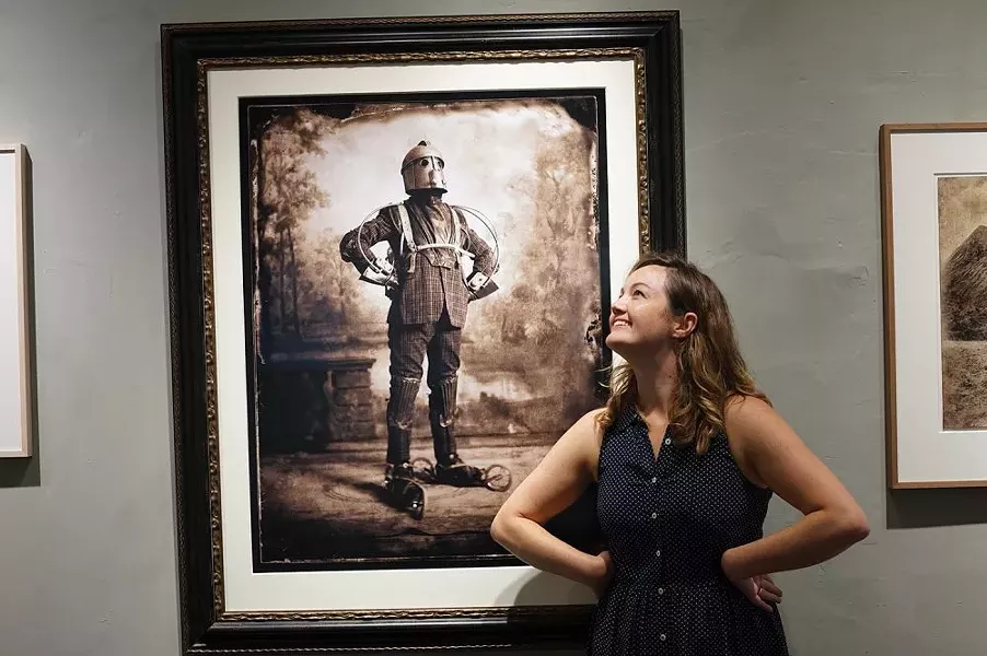 Linden Scheff poses with Nick Simpson’s The Perambulator at Carrie Haddad Gallery in Hudson. - PHOTO BY JOHN GARAY