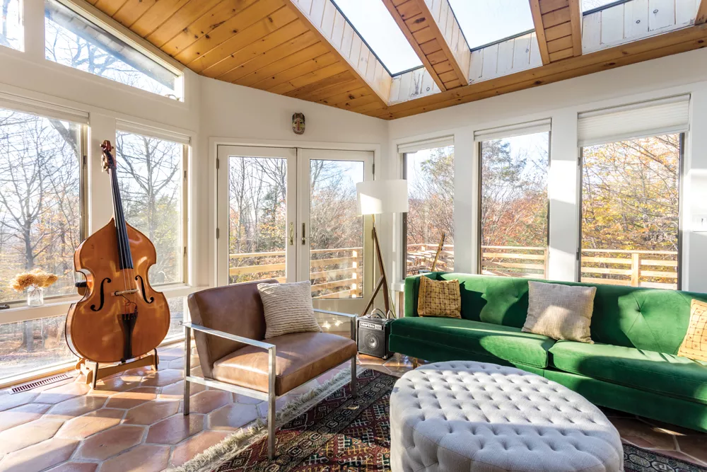 The music room of Sree Kant and Annie Duflo’s house is flooded with light. Once a sun porch, the west-facing room enjoys views of the nearby Catskill Mountains and lush winter sunsets. It’s the perfect place to practice an - instrument—a favorite pastime for both Duflo, who plays the piano, and Kant, who is learning the bass. - PHOTOS BY WINONA BARTON-BALLENTINE