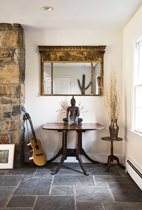 The bluestone-tiled entrance to Susan Coleman's 4,000 square-foot Colonial. Coleman, a mediator who focuses on international conflict resolution, regularly travels the world to help large groups and small negotiate their way towards peace. Her home is decorated with mementos from her journeys. "I'm all about integration," she explains, "and helping people with difficult conversations. When handled in the right way, those difficult conversations can be transformative." - DEBORAH DEGRAFFENREID