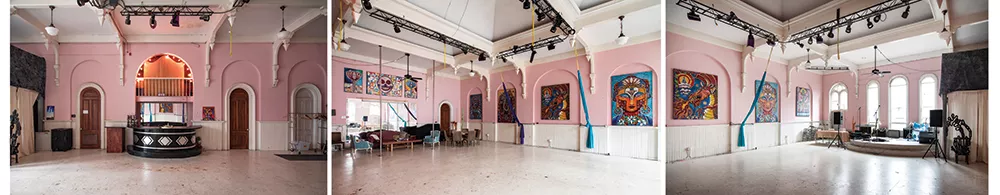 Once the center of Odd Fellows revelry, Bickman now utilizes the building’s third floor ballroom as a community event space. Musical performances, aerial yoga and her Mural Arts Program are regularly held in the 24-foot-high room. Her 4’ by 6’ Laughing at Death hangs above the mirror. Hanging amongst the arches, her 5’ by 7’ series contemplating spiritual themes was completed during her time in Florida. From left to right is Dancing Shiva, Vajrayogini, Taming the Mind, Christ Buddha, and Green Tara. - PHOTOS BY DEBORAH DEGRAFFENREID