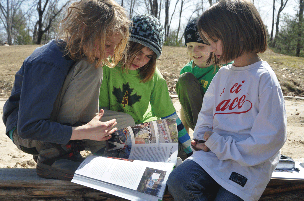 Ulysses, Amelia, Lucie, and Cady, students at the Hudson Valley Sudbury School in Woodstock, look at playground design possibilities.