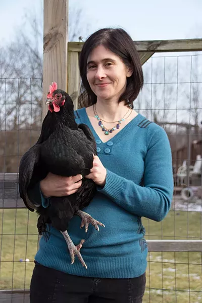 Winnie Abramson in the garden with her favorite chicken, Po. - PETER BARRETT