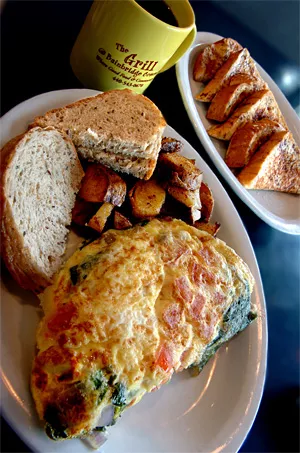 A fluffy omelet, toast, and home fries are joined by French toast and a cup o' joe for a diner-style breakfast quintet. - WALTER NOVAK