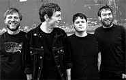 Against Me!'s Tom Gabel (center) keeps an eye on his van's tires.