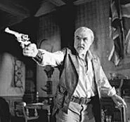 Allen Quatermain (Sean Connery) shoots at bad guys.