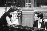 Andrs tickles the ivories and ogles the boobies.
