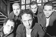 Before landing a record deal, Ike Reilly (center) worked - in a cemetery and as a hotel doorman.