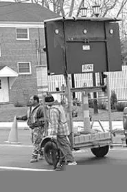 Blaze workers retouch lane lines at the company's - latest botched job on Bagley Road. - WALTER NOVAK