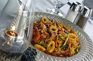 Calamari, sweet pepper, and crisp carrots mingle in a seductively spicy glaze. - WALTER NOVAK