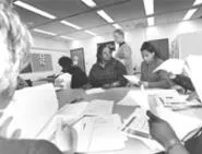 Helping hands: Anderson (standing), with Gwendolyn - Garth (center) and Alana Johnson (right). - WALTER NOVAK