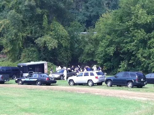 Investigators congregate at the treeline at Clark Fields Oct. 2.