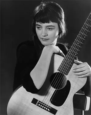 Karen Dalton and her guitar strike a pensive mood.