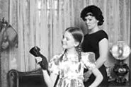 Little Rhoda casts a satisfied grin toward her weapon of choice.