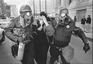 Memphis police help a woman overcome by tear gas. - LANCE MURPHEY/THE COMMERCIAL APPEAL