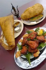 Potato-stuffed samosas, chicken jhalfrazie, and puffy fried bhatura will put carnivores and veggie-heads alike in a much better mood. - WALTER NOVAK