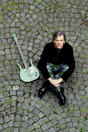 Robyn Hitchcock and his guitar soak up some rays.