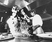 Romel Samblero fires up the grill. - WALTER NOVAK