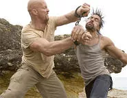 Steve Austin (left) reacts predictably to Manu Bennett's bad hair.