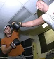 The commander (left) delivers one of his walloping blows to the arm. - WALTER NOVAK