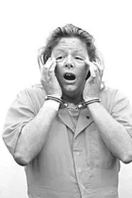 The real Aileen Wuornos, freaky lack of eyebrows and - all, strikes a scary pose.