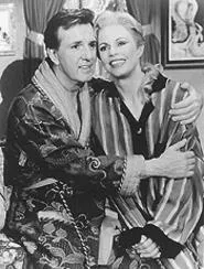 Toddy (Jamie Ross) snuggles up to the "Victoria" side of Toni Tennille in Victor/Victoria.