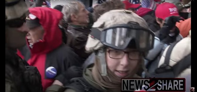 A still from footage of the riots in Washington D.C. captures Jessica Watkins, 38, seen with several people in Oathkeepers regalia, heading up the Capitol stairs. Screenshot from YouTube, credit Ford Fischer / News2Share.