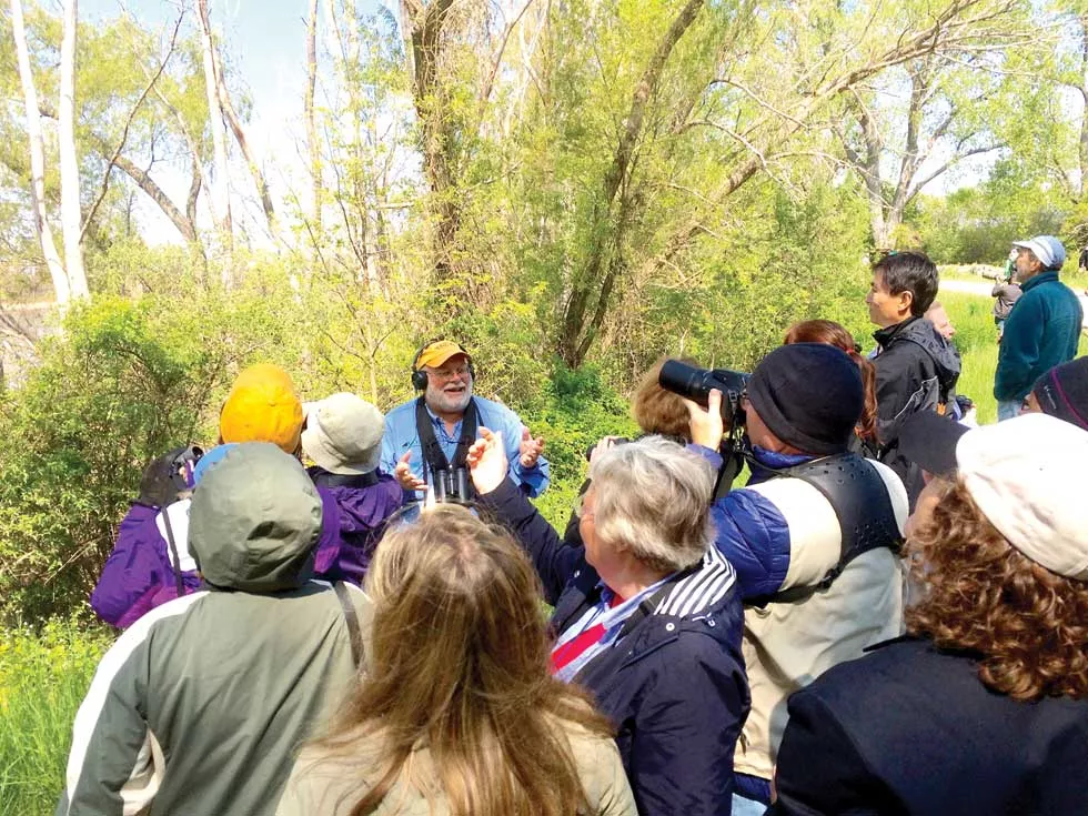 Greg Miller offers birding wisdom to a group at Magee Marsh. - PHOTO BY ERIC SANDY