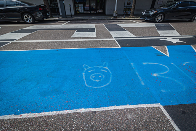 A cartoon pig spray painted on the Back the Blue mural - DAVE DECKER