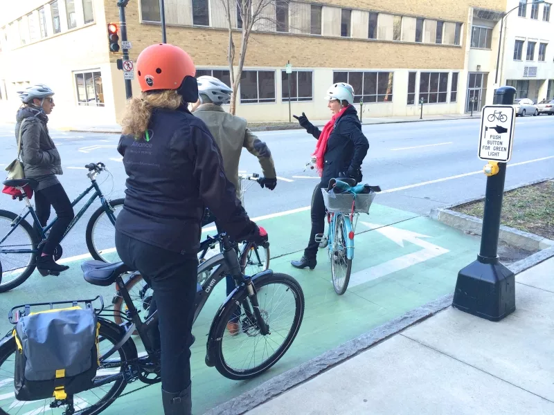 A dedicated bike signal and two stage turn helps 5th Street bike lane users cross West Peachtree Street.