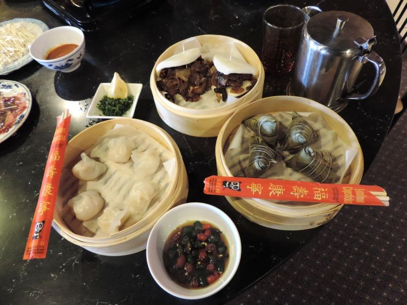 Clockwise from top: Hanbaobao (Chinese burgers), Zongzi, Mala sauce, Shrimp