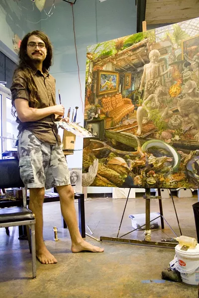 Painter Isaac McCaslin in his Starland District studio working to complete his final piece for the Telfair Art Fair this weekend.