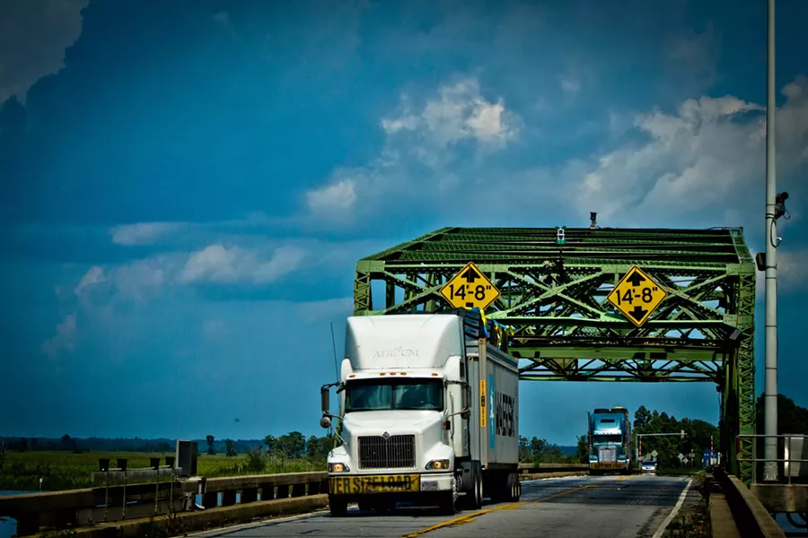Trucks cross the historic Houlihan Bridge at Pt. Wentworth. - JON WAITS/@JWAITS