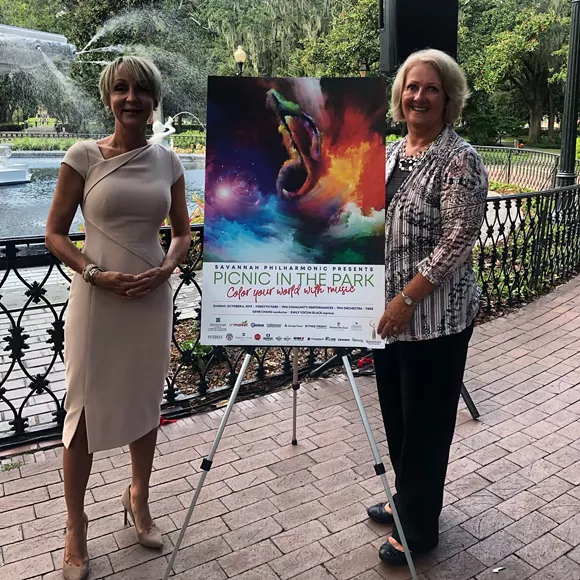 Executive Director Terri O'Neil and theme contest winner Lucinda Shultz pose with the official Picnic in the Park poster.