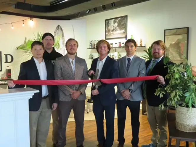The founders of Avaloo Hemp at the 2020 Grand Opening of Gainesville’s Avaloo Hemp Shop (Chosewood with scissors and Moen to his right, in center)